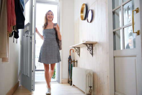 woman-entering-house-through-aluminium-front-door