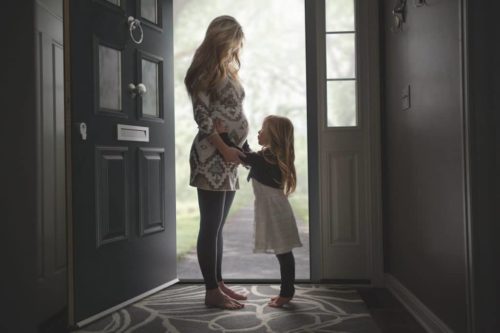 mother-and-daughter-standing-in-high-security-front-door